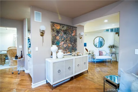 a living room with furniture and a mirror