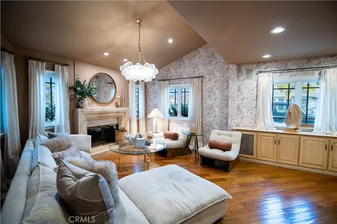 a living room with furniture a fireplace and a large window