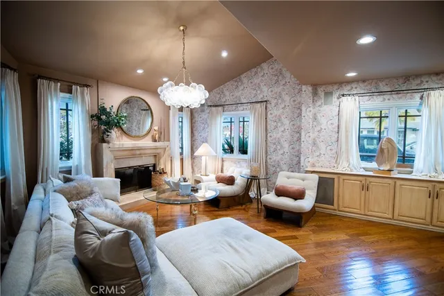 a living room with furniture a fireplace and a large window