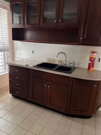 a kitchen with a sink and cabinets