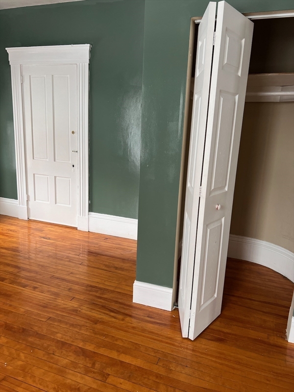 1 Congress Street, Unit 1 Worcester, MA 01609 - Photo 6 of 15 an empty room with wooden floor and entrance