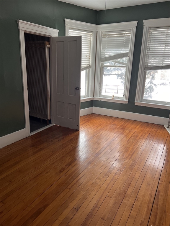 1 Congress Street, Unit 1 Worcester, MA 01609 - Photo 8 of 15 an empty room with wooden floor and windows