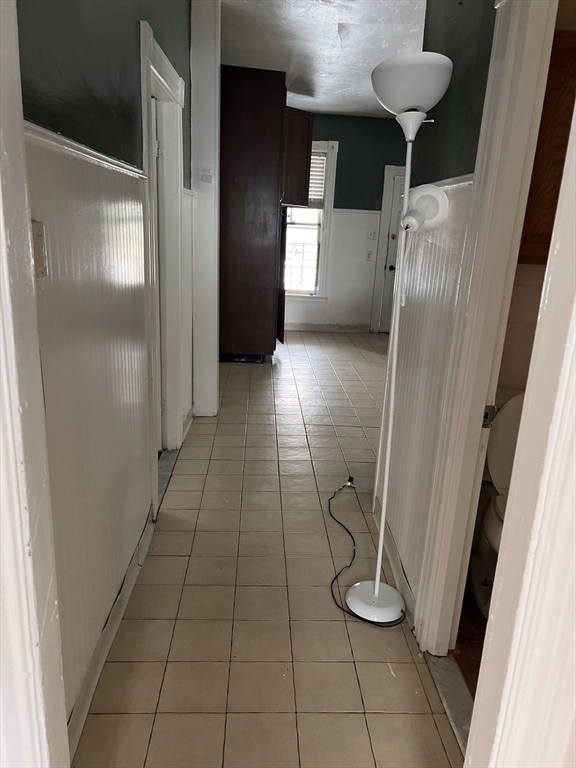 1 Congress Street, Unit 1 Worcester, MA 01609 - Photo 10 of 15 a view of a refrigerator in kitchen and an empty room
