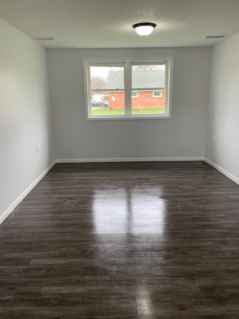 730 South High Street Paxton, IL 60957 - Photo 11 of 14 an empty room with wooden floor and windows