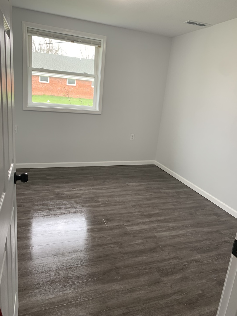 730 South High Street Paxton, IL 60957 - Photo 7 of 14 a view of room with window and wooden floor