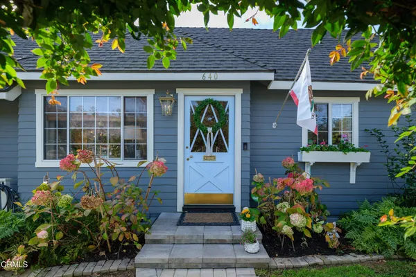 a front view of a house with a garden