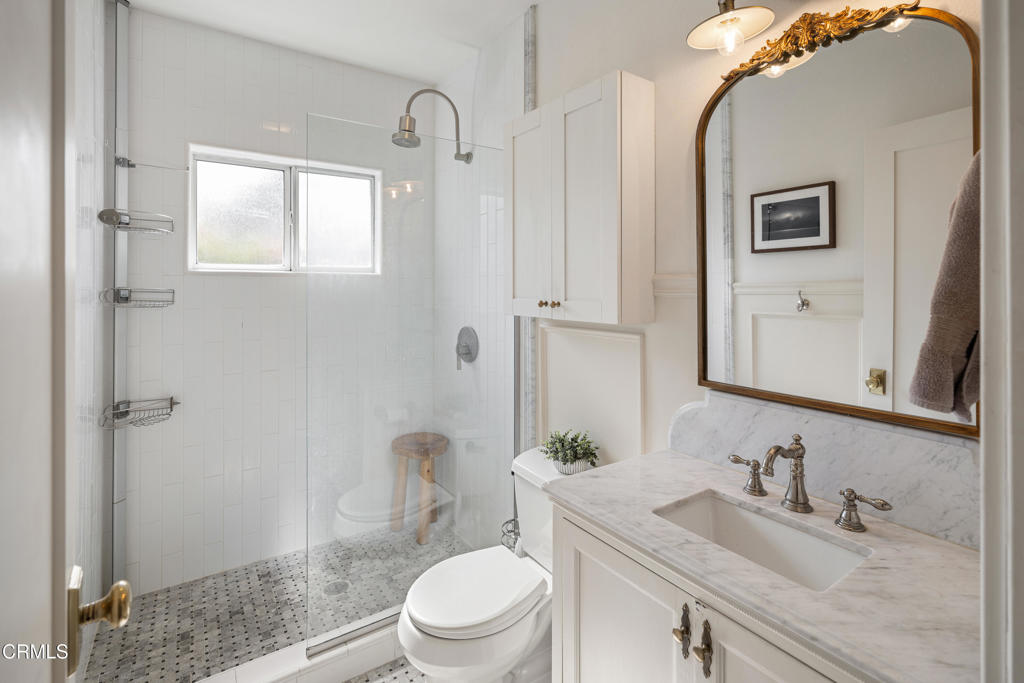 640 East Rio Grande Street Pasadena, CA 91104 - Photo 27 of 61 a bathroom with a granite countertop toilet a sink and a mirror