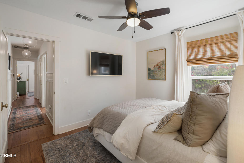 640 East Rio Grande Street Pasadena, CA 91104 - Photo 30 of 61 a bedroom with a large bed a flat tv screen and a walk in closet