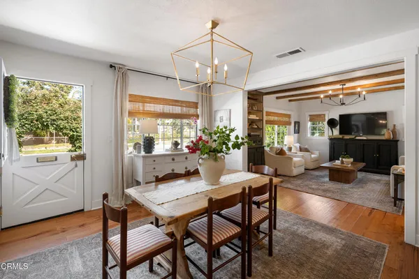 a view of a dining room with furniture window and wooden floor