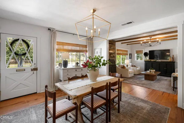a view of a dining room with furniture window and wooden floor