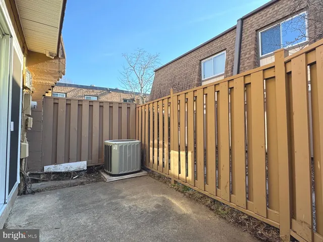 a backyard of a house with chairs and stairs