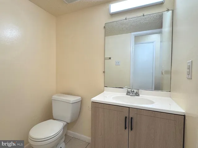 a bathroom with a sink a toilet and mirror