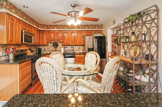 a dining room with furniture and a chandelier