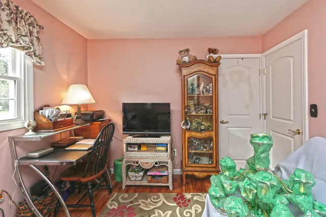 a living room with furniture a chandelier and a window