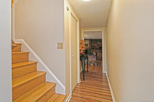 a view of a hallway with wooden floor and entryway