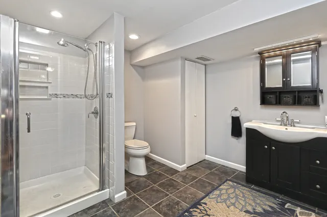 a bathroom with a sink toilet and shower