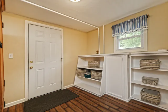 an empty room with windows and cabinet