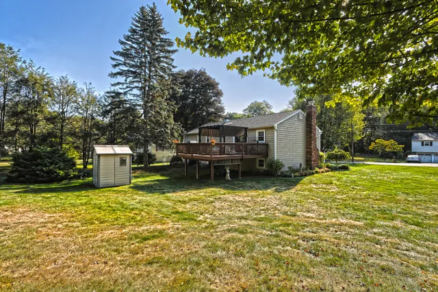 a view of a house with pool and sitting area