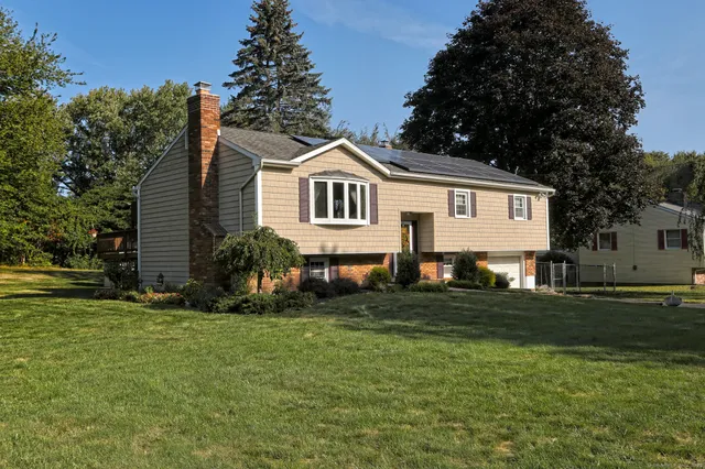 a front view of a house with a garden