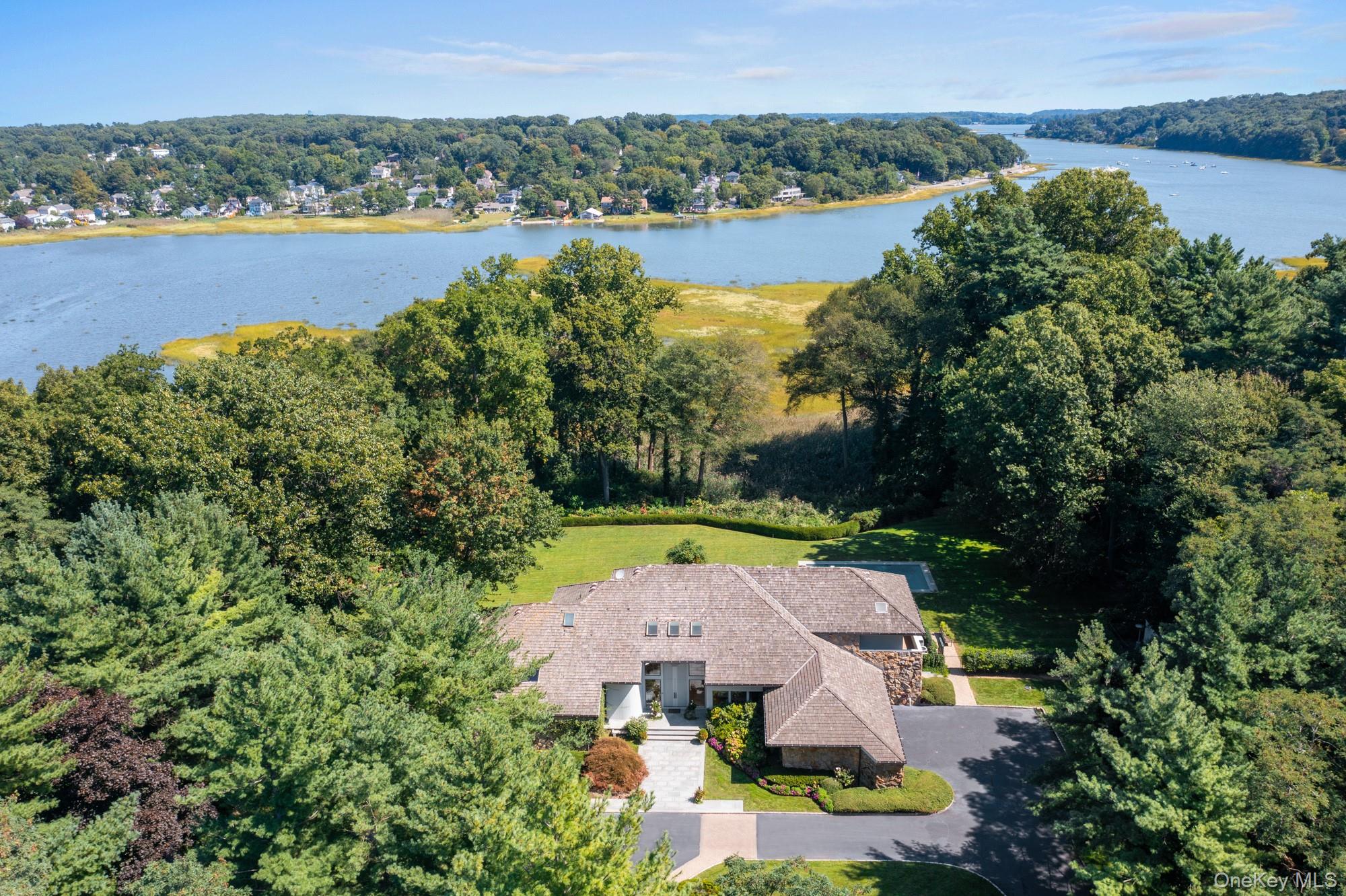 8 Mill Pond Lane Locust Valley, NY 11560 - Photo 1 of 38 an aerial view of a house with outdoor space and lake view