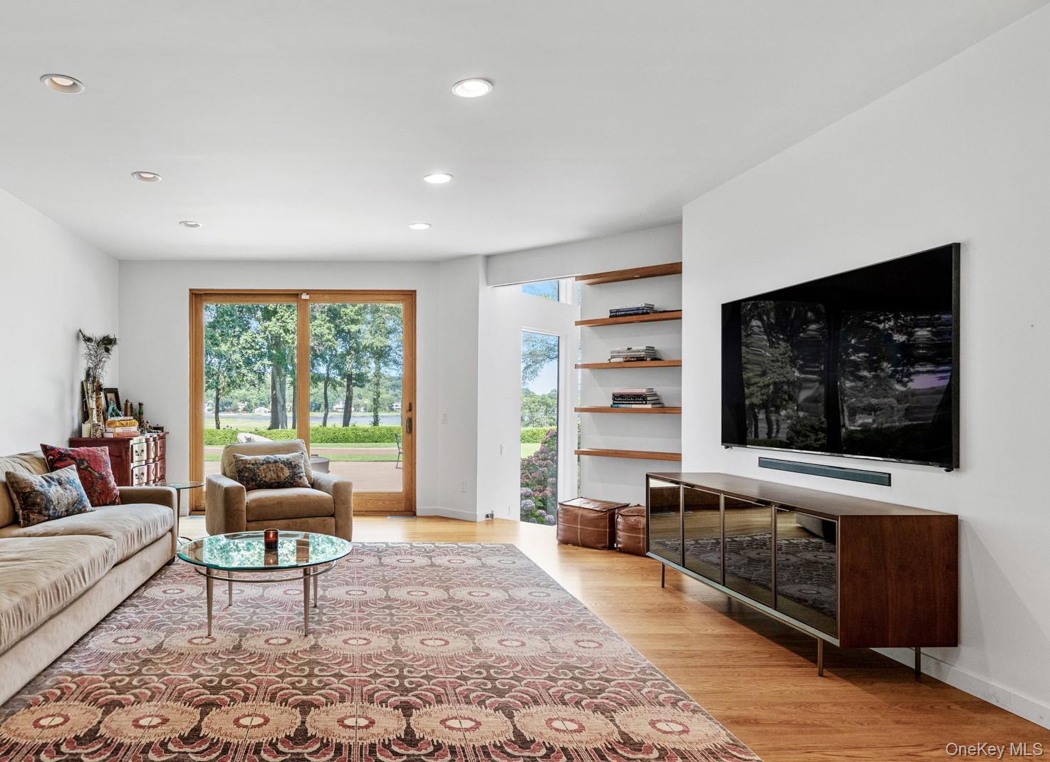 8 Mill Pond Lane Locust Valley, NY 11560 - Photo 12 of 38 a living room with furniture and a flat screen tv