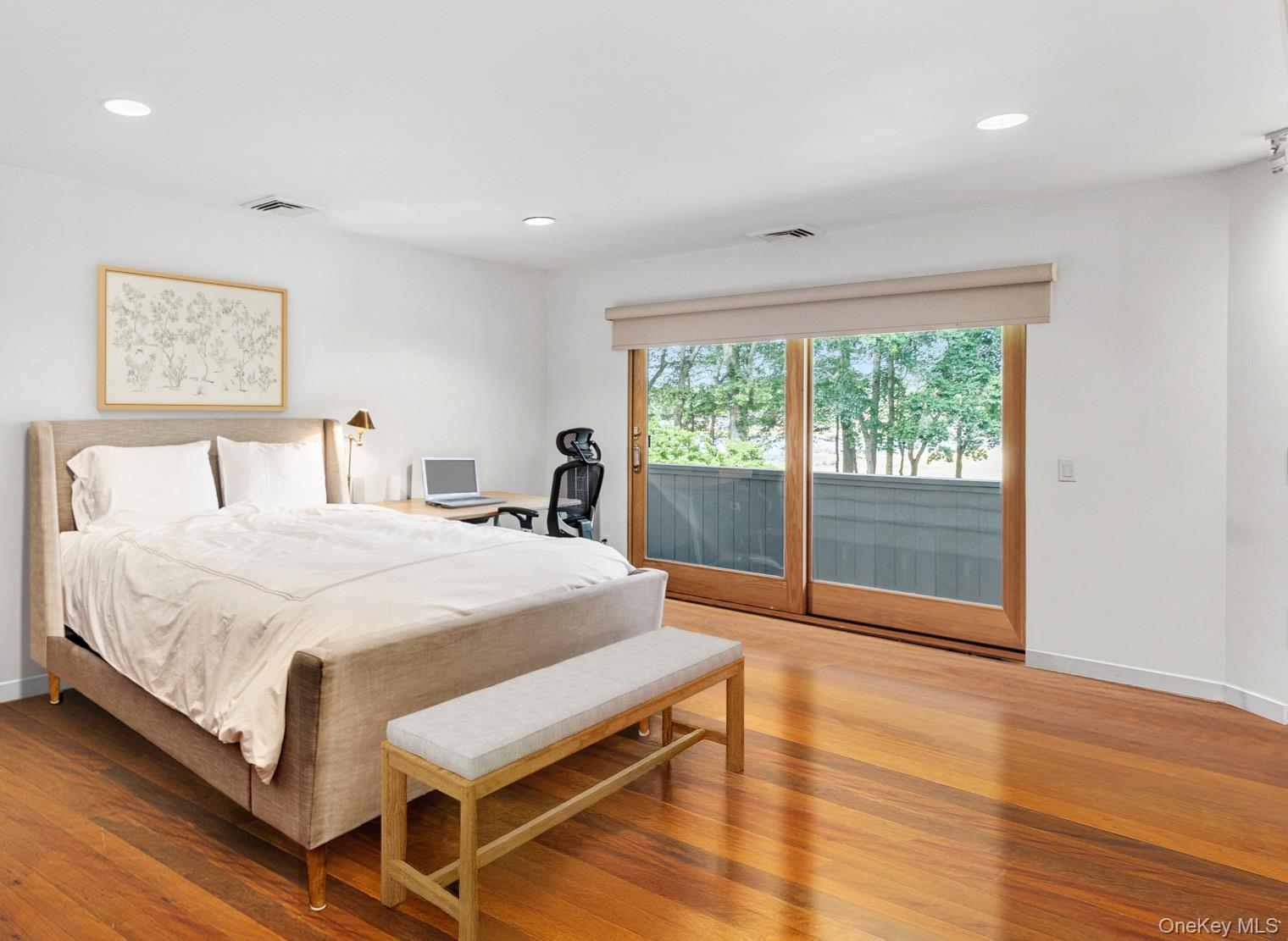 8 Mill Pond Lane Locust Valley, NY 11560 - Photo 21 of 38 a spacious bedroom with a bed and wooden floor