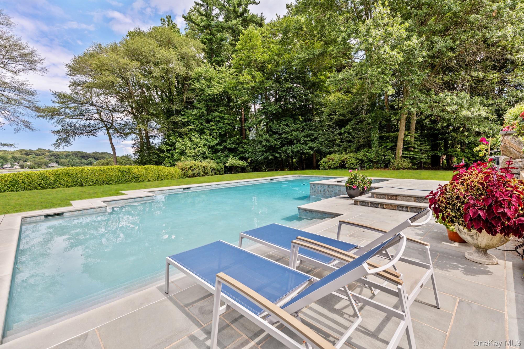 8 Mill Pond Lane Locust Valley, NY 11560 - Photo 29 of 38 a view of a patio with a table and chairs under an umbrella