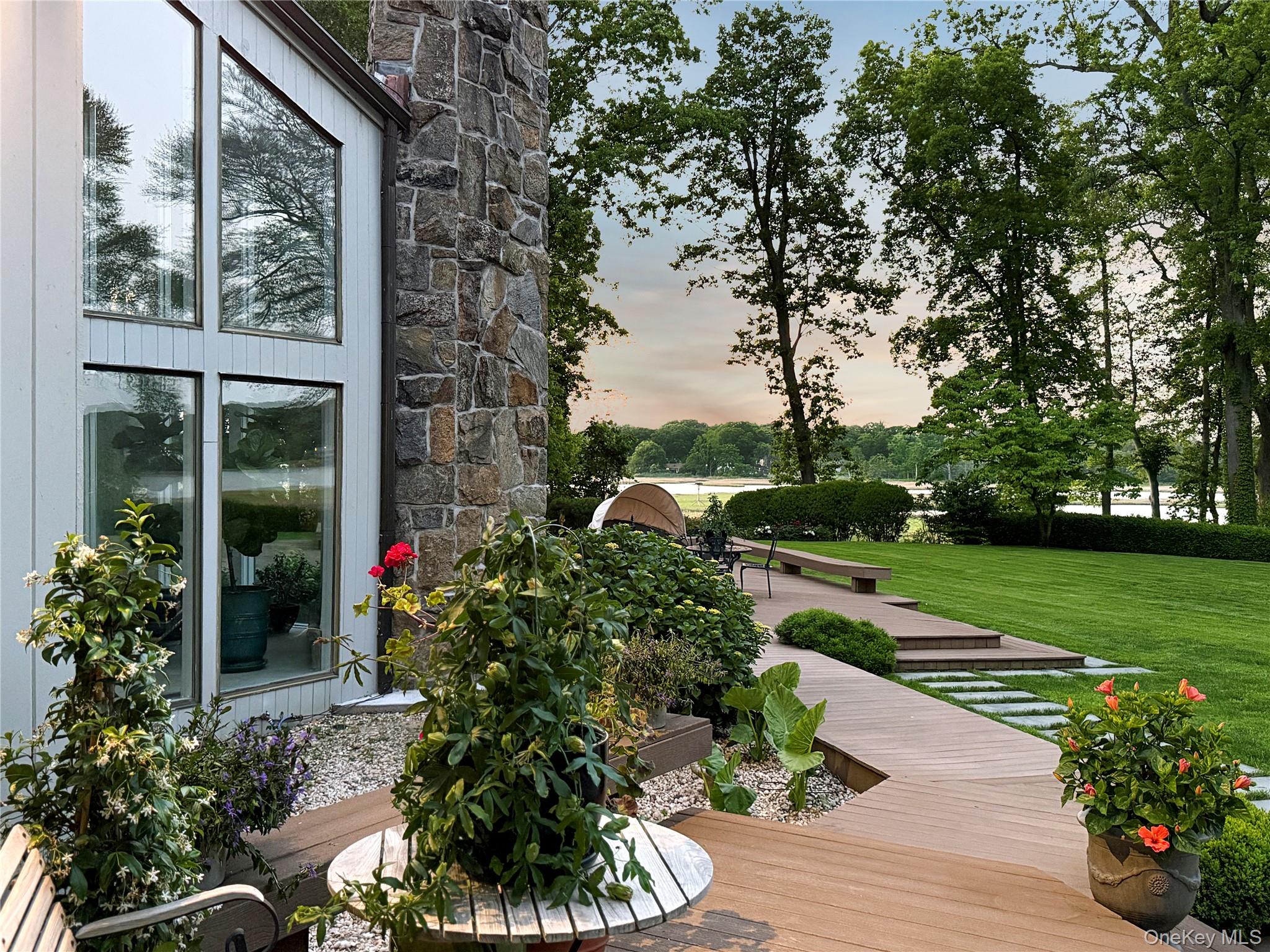 8 Mill Pond Lane Locust Valley, NY 11560 - Photo 31 of 38 a front view of a house with garden