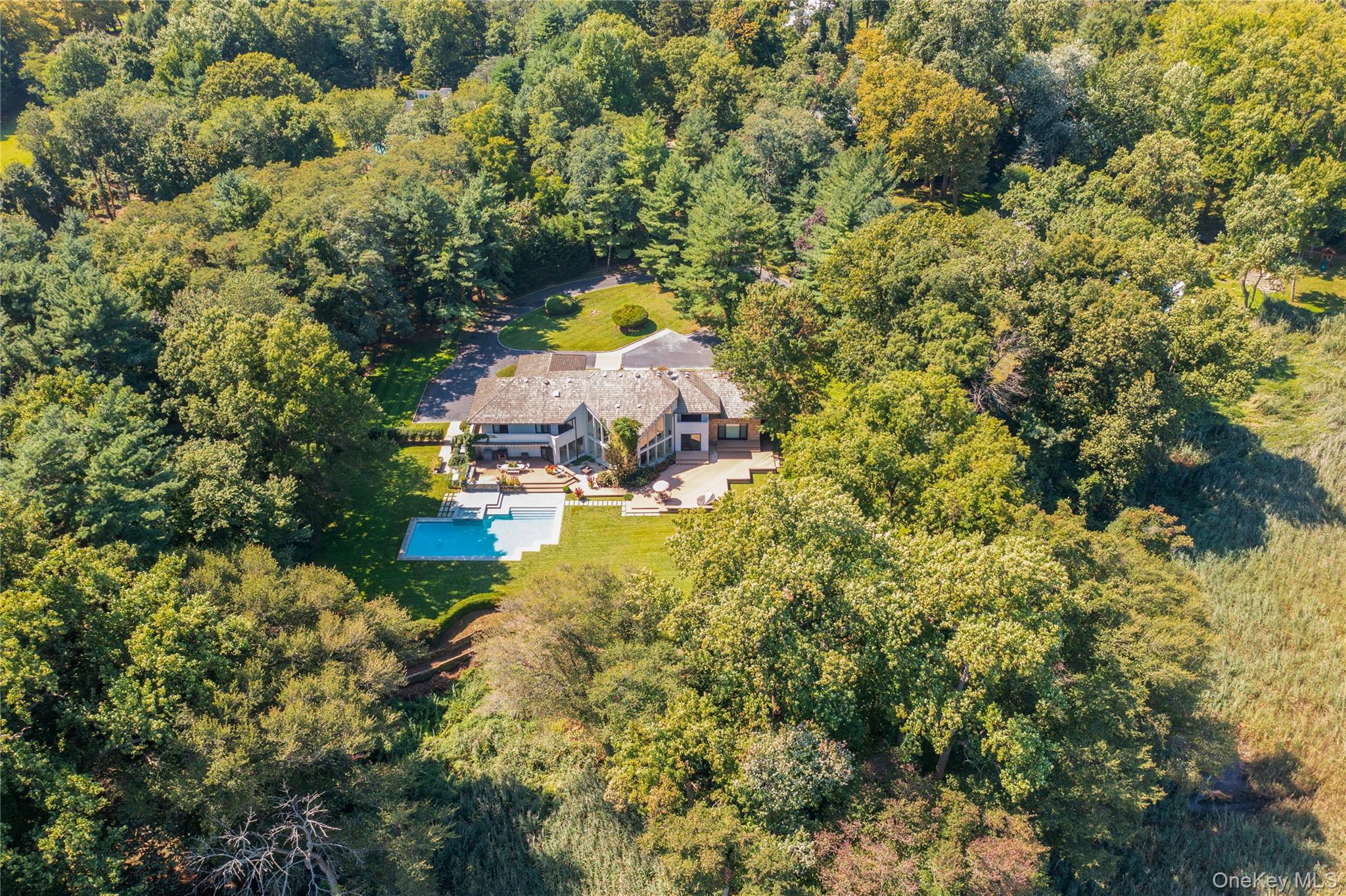 8 Mill Pond Lane Locust Valley, NY 11560 - Photo 37 of 38 an aerial view of residential houses with outdoor space and trees