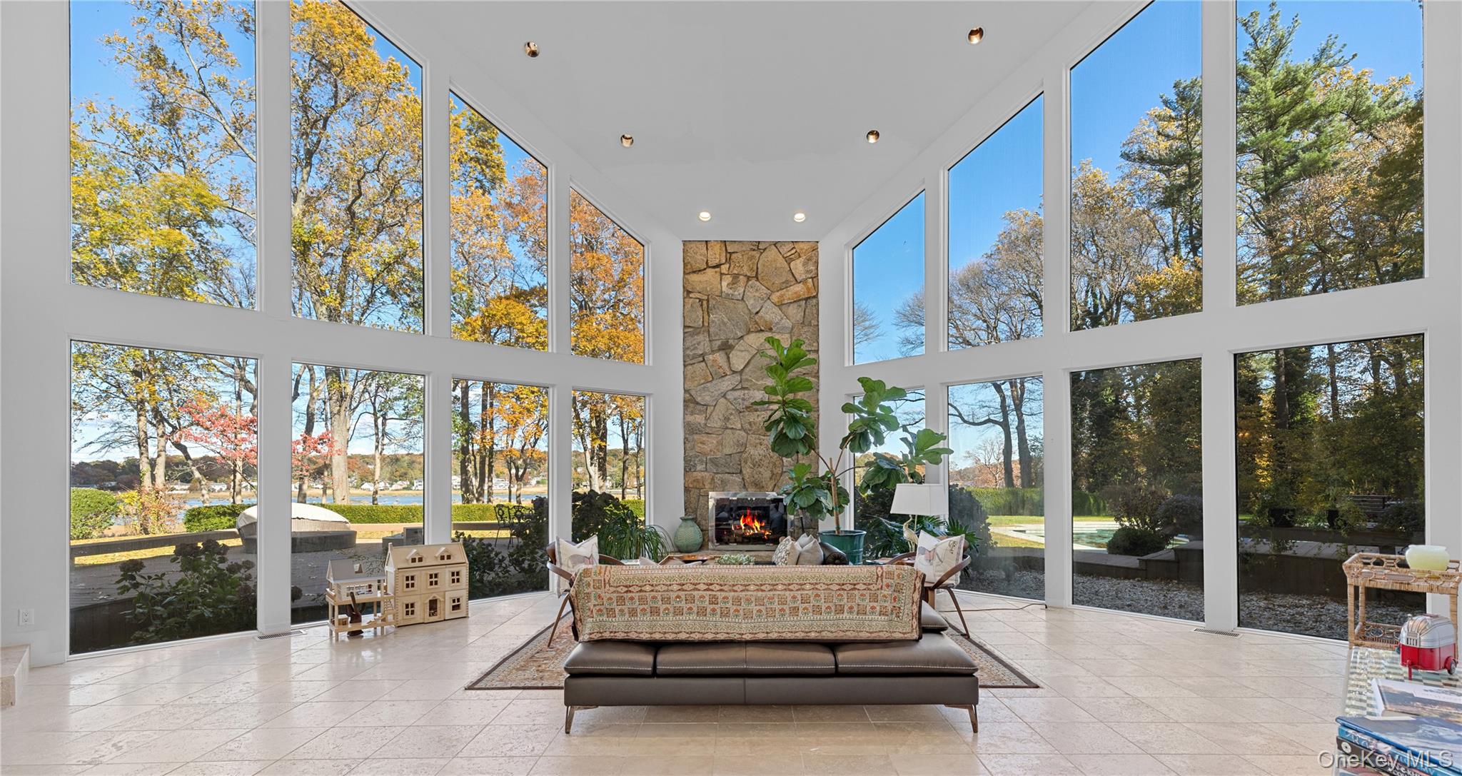8 Mill Pond Lane Locust Valley, NY 11560 - Photo 6 of 38 a living room with fireplace furniture and a large window