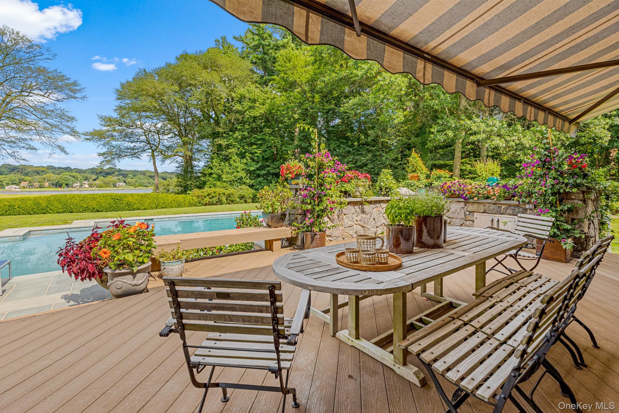8 Mill Pond Lane Locust Valley, NY 11560 - Photo 10 of 38 a view of a chairs and table in patio