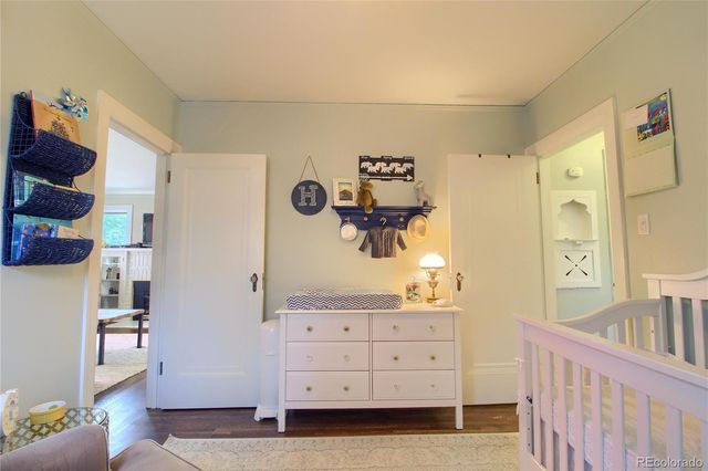 a bedroom with a baby bed baby crib and a dresser