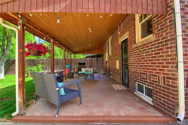 a view of a patio with table and chairs and potted plants