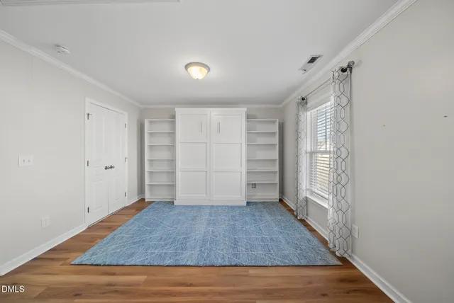 a view of walk in closet with empty racks