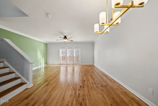 a kitchen with stainless steel appliances granite countertop a refrigerator a stove top oven and wooden floor