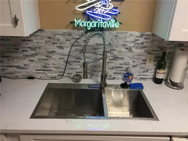 a view of a kitchen with wooden floor and a sink