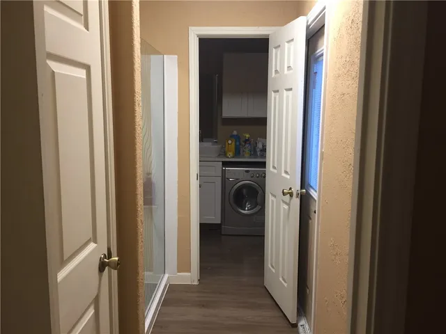 a view of a hallway with a washer and dryer