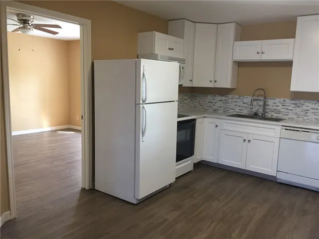 a white refrigerator freezer sitting inside of a kitchen