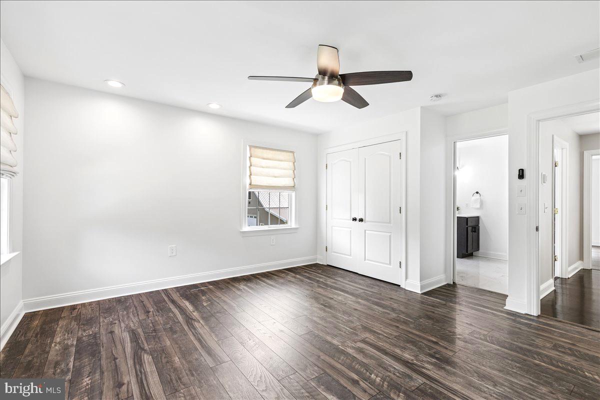 102 Little Neck Road Stevensville, MD 21666 - Photo 49 of 77 a view of empty room with wooden floor and fan