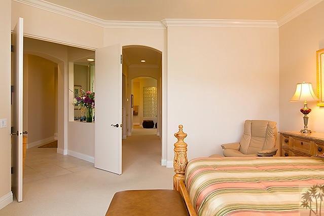 152 Loch Lomond Road Rancho Mirage, CA 92270 - Photo 13 of 26 a bedroom with a bed and lamp