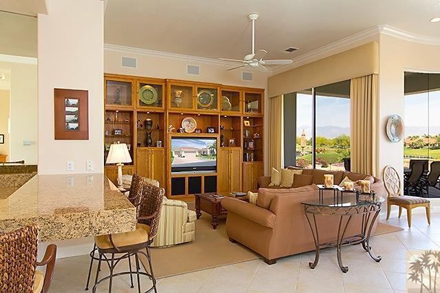 152 Loch Lomond Road Rancho Mirage, CA 92270 - Photo 7 of 26 a living room with furniture a flat screen tv and floor to ceiling window