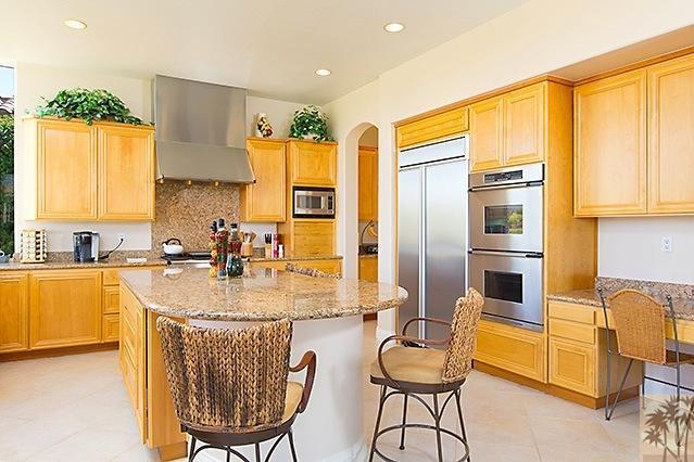 152 Loch Lomond Road Rancho Mirage, CA 92270 - Photo 10 of 26 a kitchen with stainless steel appliances granite countertop a stove a sink and a refrigerator