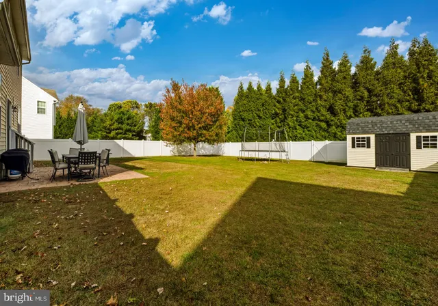 a view of a swimming pool with an outdoor seating and a yard