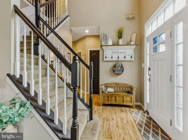 a view of entryway hall with wooden floor