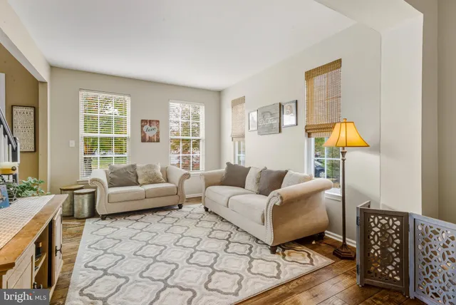 a living room with furniture a lamp and a window