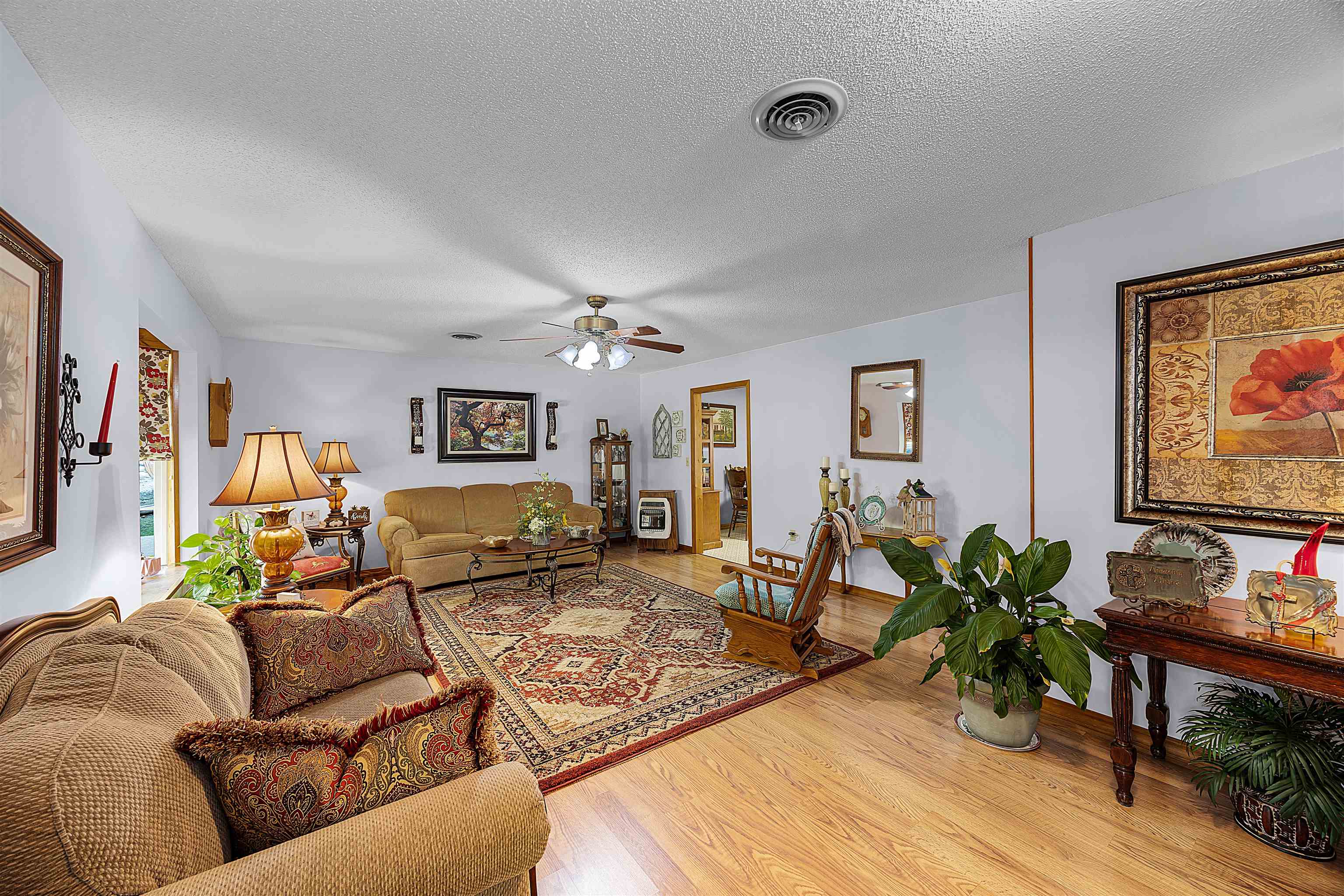 61 Cr 303 Road Iuka, MS 38852 - Photo 7 of 19 Living room with a textured ceiling, light wood-type flooring, and ceiling fan