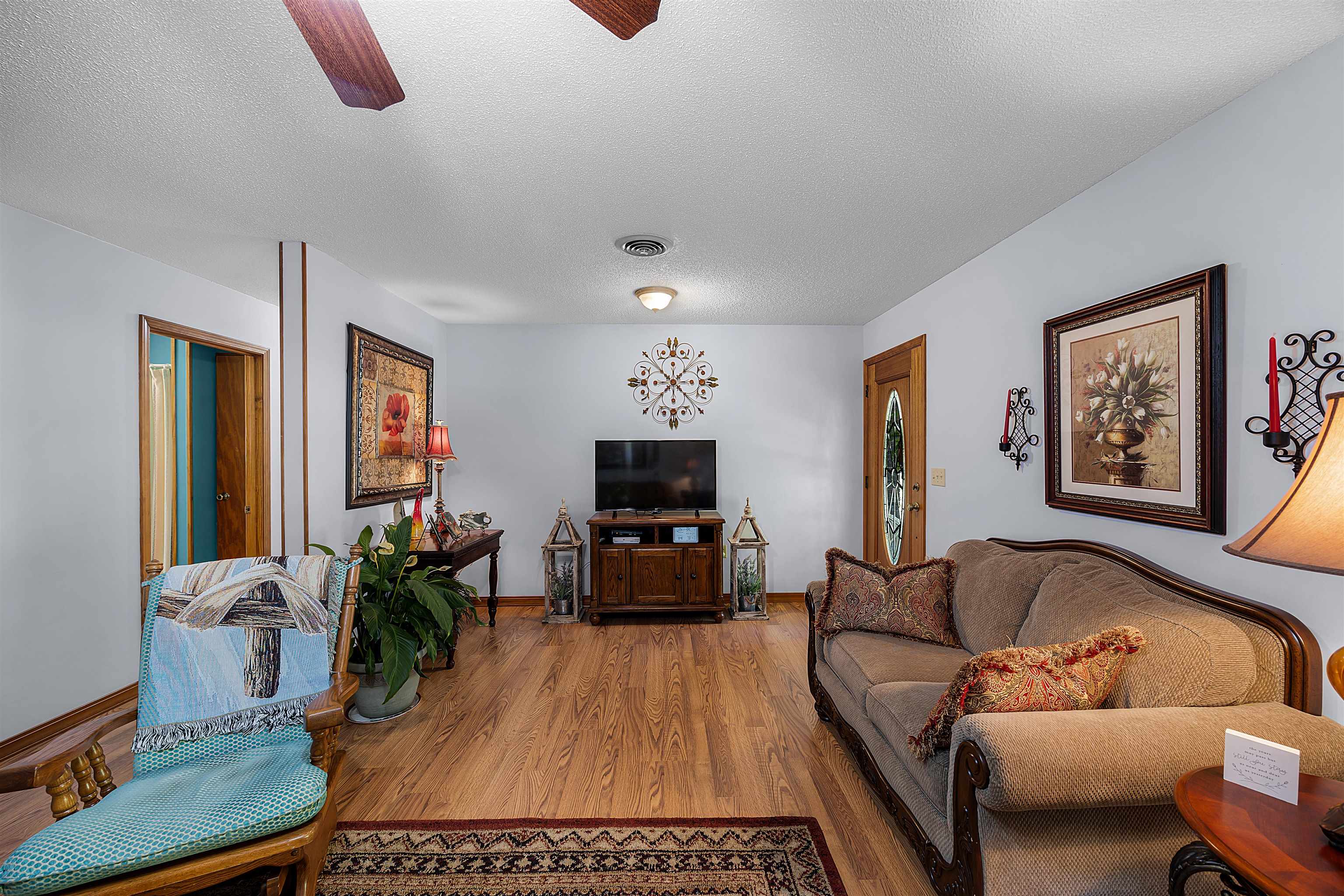 61 Cr 303 Road Iuka, MS 38852 - Photo 9 of 19 Living room featuring ceiling fan, a textured ceiling, and hardwood / wood-style floors