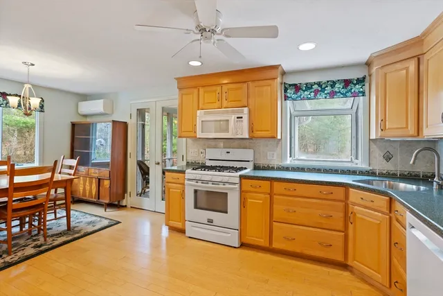 a kitchen with stainless steel appliances granite countertop a stove and a refrigerator