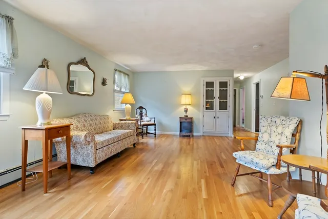 a bedroom with furniture and wooden floor