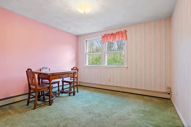a dining room with furniture and window